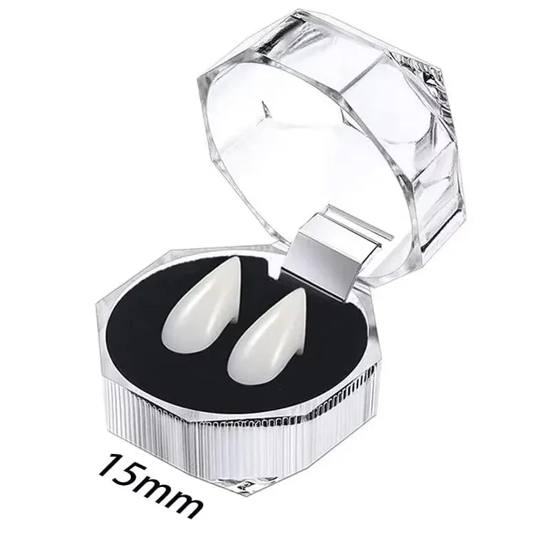 Clear plastic container holding realistic white vampire fangs for costumes