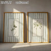 Set of two unframed 2D flat canvas prints featuring sage green floral designs in striped frames.