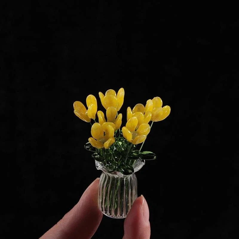 Handcrafted mini glass flower sculpture with yellow blossoms in a clear glass vase