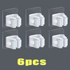 Six white wall mounted holders for storing mops and brooms.