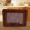 A wooden savings box with a progress tracker showing various dollar amounts.
