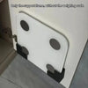 A white support frame for a weighing scale is mounted on a wall, showing the structure without the scale.