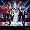 A group of six collectible plush figures dressed in various outfits performing on a stage with bright spotlights.