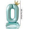 A large, light blue foil number balloon shaped like the digit zero, topped with a gold crown.