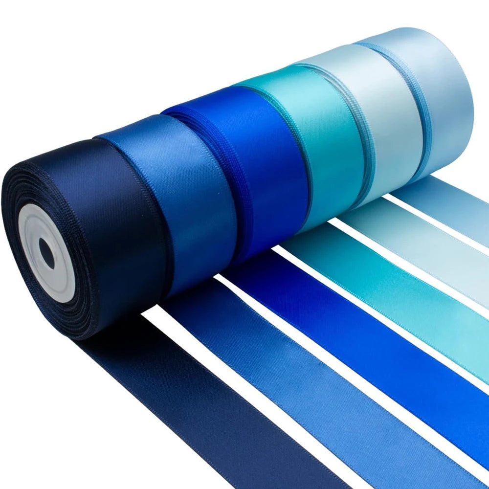A roll of satin silk ribbon in various shades of blue and teal, showing the colorful ribbons unwound.