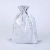 A silver drawstring gift bag with snowflake and festive designs.