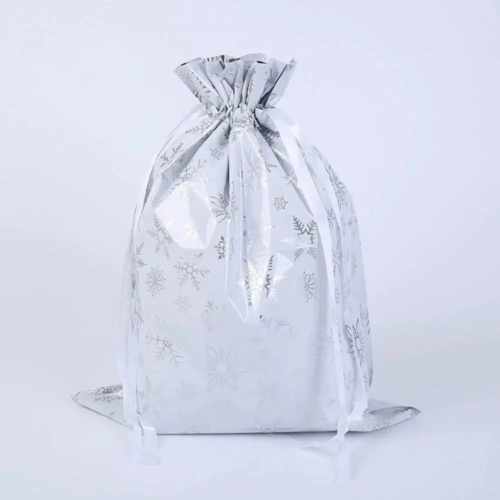 A silver drawstring gift bag with snowflake and festive designs.