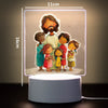 A 3D LED night light featuring a family of seven children and one adult, illuminated on a square panel.