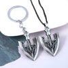 Silver arrow metal keychain with an anchor design attached to a black cord