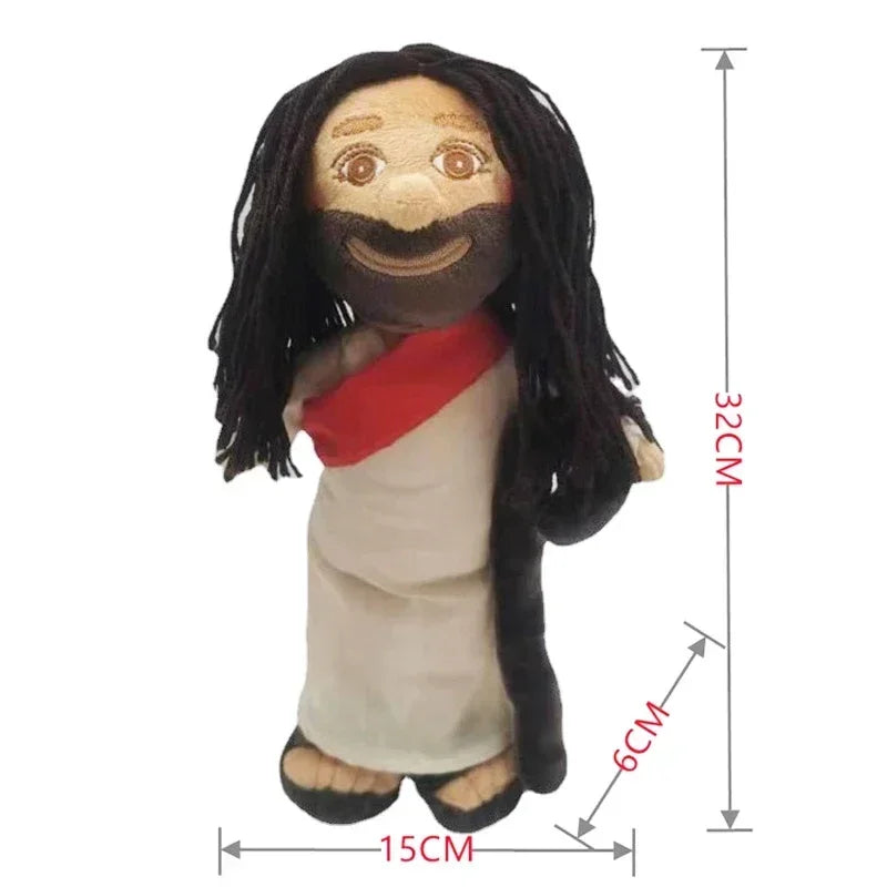 A religious plush doll depicting Jesus with long black hair and a beard, wearing a white garment and a red sash.