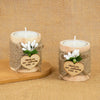 Two rustic wooden tealight candle holders wrapped in twine with a thank you message and white flowers.
