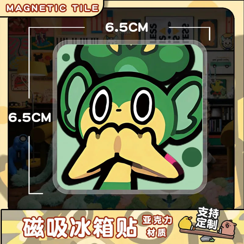 A set of magnetic tiles featuring a green, stylized Pokémon character face.