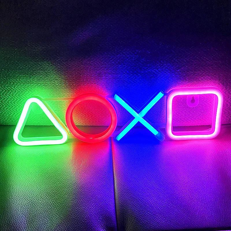 Affichage lumineux néon avec des icônes géométriques colorées comme un triangle, un cercle et une croix sur une surface sombr