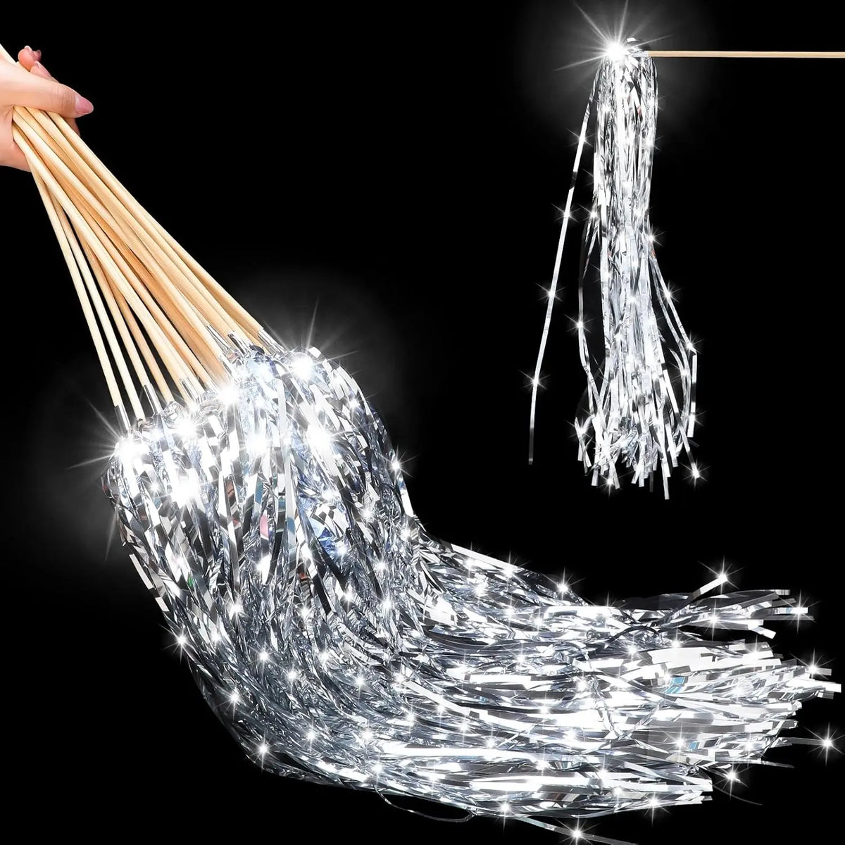 A bundle of silver lighted tinsel wedding wands with LED glow hanging against a black background.