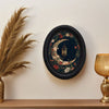 Black framed wall art featuring a detailed illustration of a crescent moon and flowers.