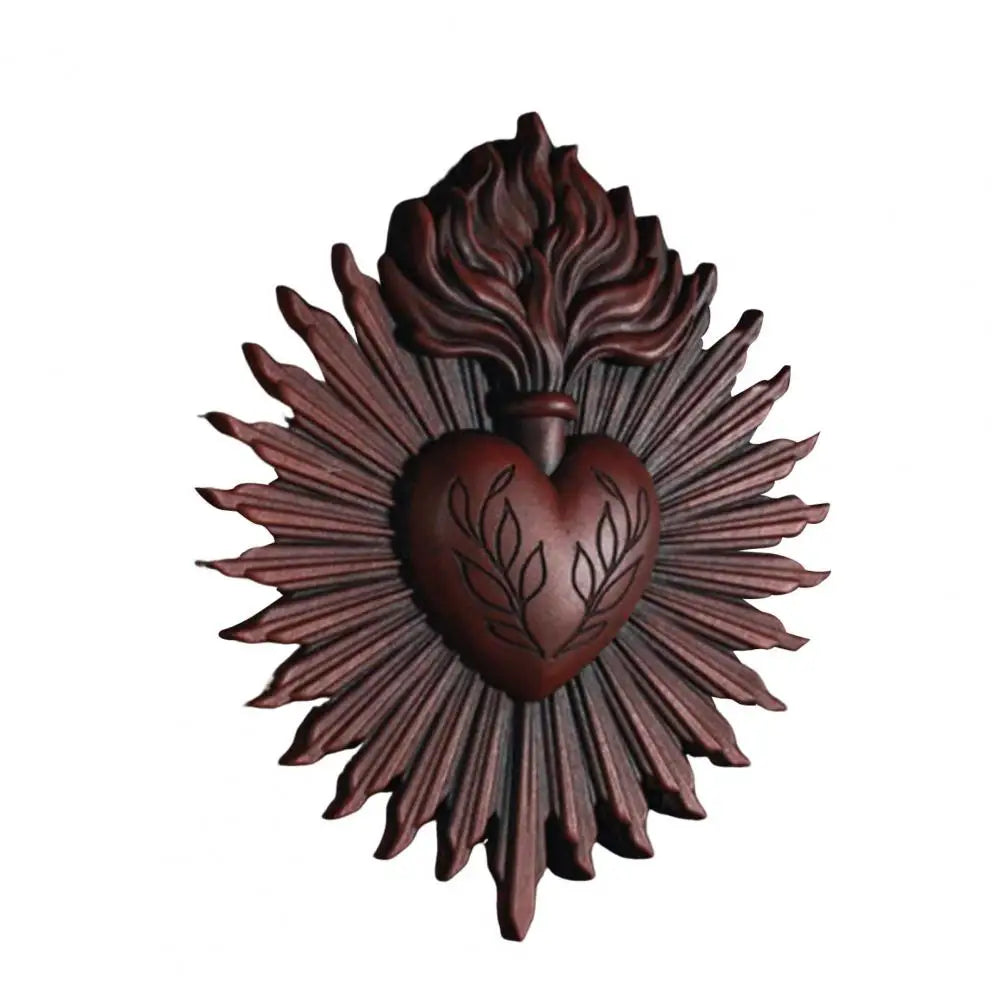 A dark brown wall plaque featuring a stylized sacred heart design with radiating lines.