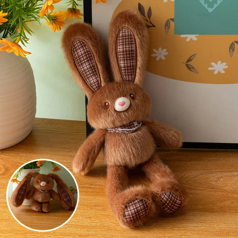 A fluffy brown rabbit plush toy with long ears and a small pink nose sitting on a wooden surface.
