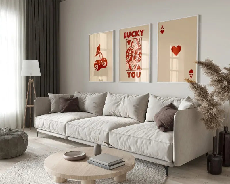 A modern living room features a light sofa, wooden coffee table, and framed retro letter art canvases on the wall.
