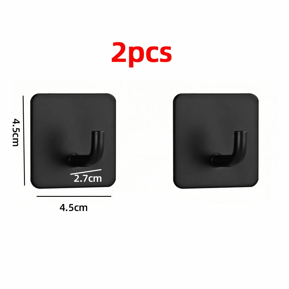 Two black stainless steel self-adhesive wall hooks shown against a white background.