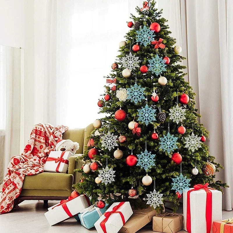 A decorated Christmas tree adorned with shimmering blue snowflake ornaments and red berries, surrounded by wrapped gifts.