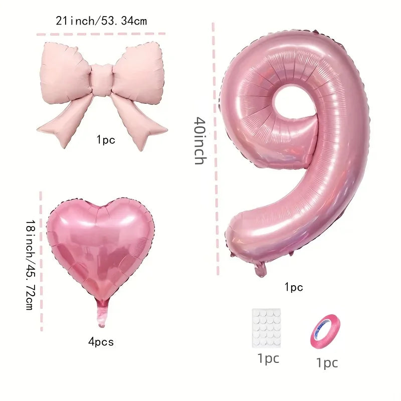 Pink foil balloons shaped like a bow, heart, and number 9 for party decoration