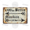 A vintage metal tin sign showing a distance measurement from Berlin to Moscow.