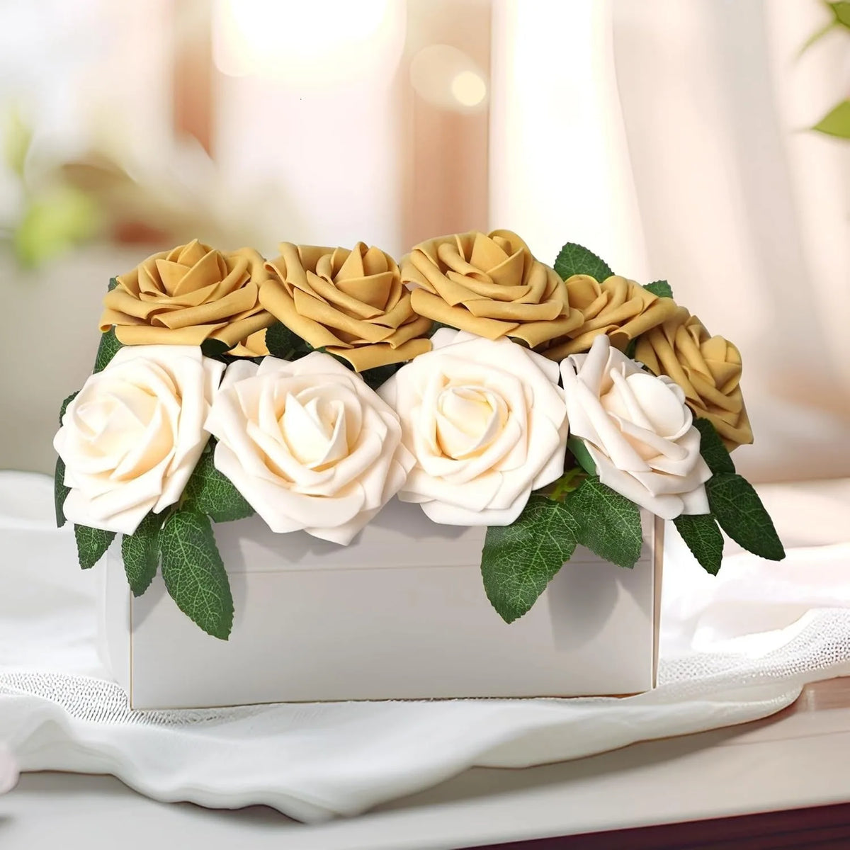 A bouquet of realistic foam roses in cream and gold colors displayed in a white box.