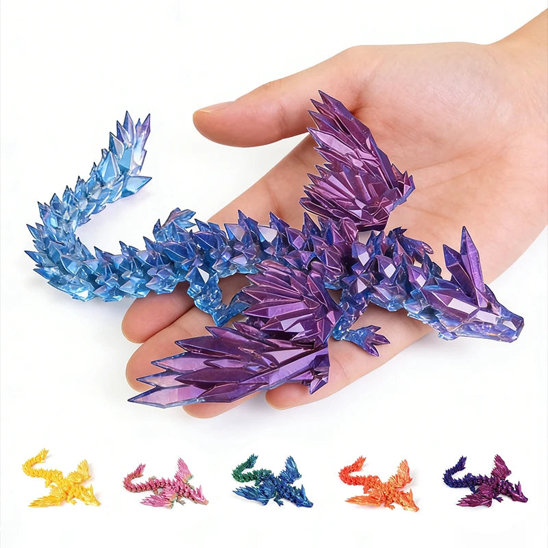 A hand holds a purple and blue 3D printed magic dragon ornament with various colored dragon shapes below.