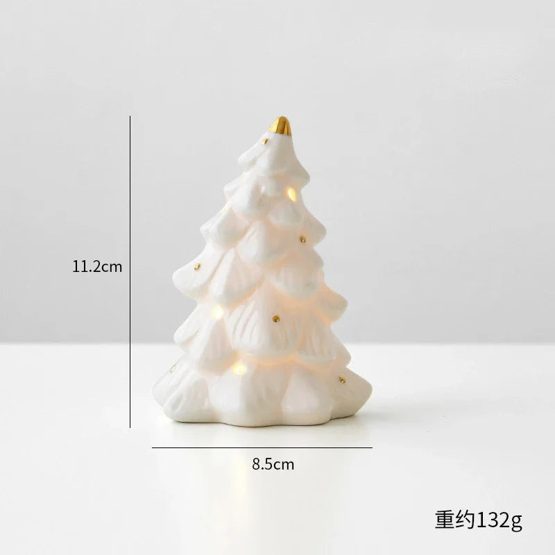 A white ceramic glow-in-the-dark mini Christmas tree decor with a gold topper.