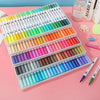 A colorful set of dual-ended watercolor art markers arranged in a plastic case on a pink surface.
