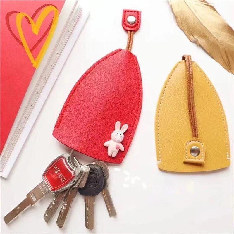 A red and yellow cartoon PU leather key holder with a pull-out design and a gold leaf accent.