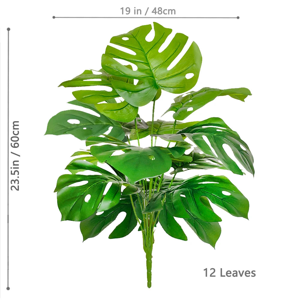 Artificial Monstera plant with silk green leaves shown against a white background.
