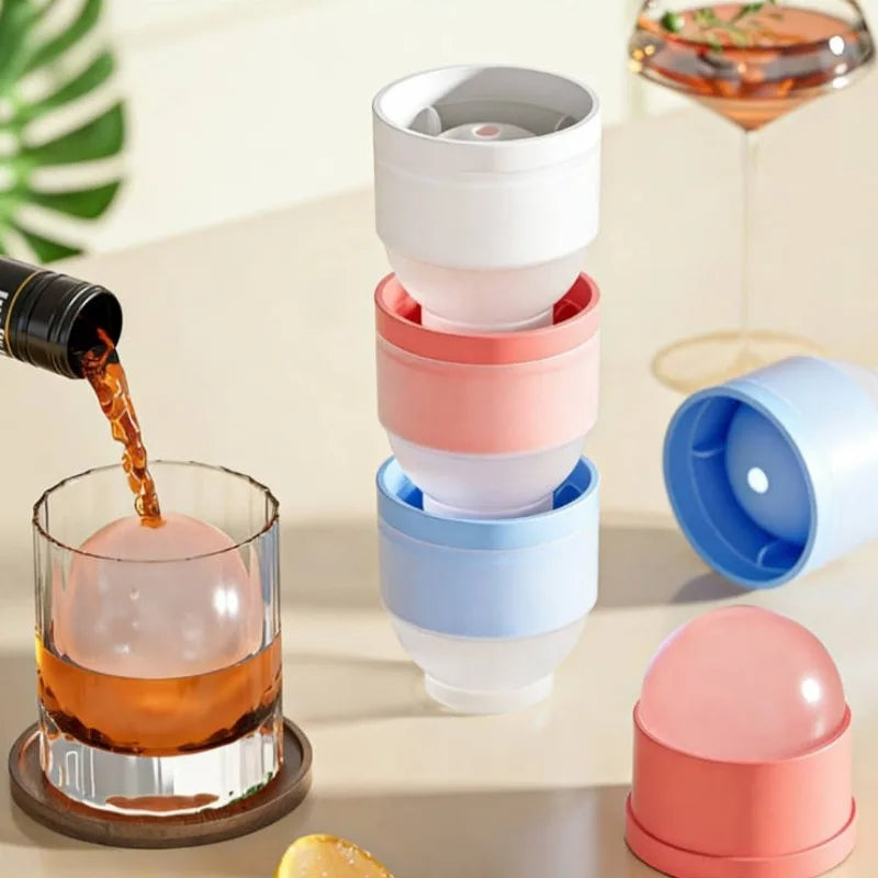 A stack of colorful spherical ice molds for whiskey and cocktails, including pink, white, and blue shades.