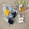 Packaged dried fruit keychains including yellow mango pieces and black grapes