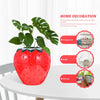 Jarrón de flor de fresa de cerámica roja brillante con hojas verdes, mostrado en diversos contextos de decoración del hogar.