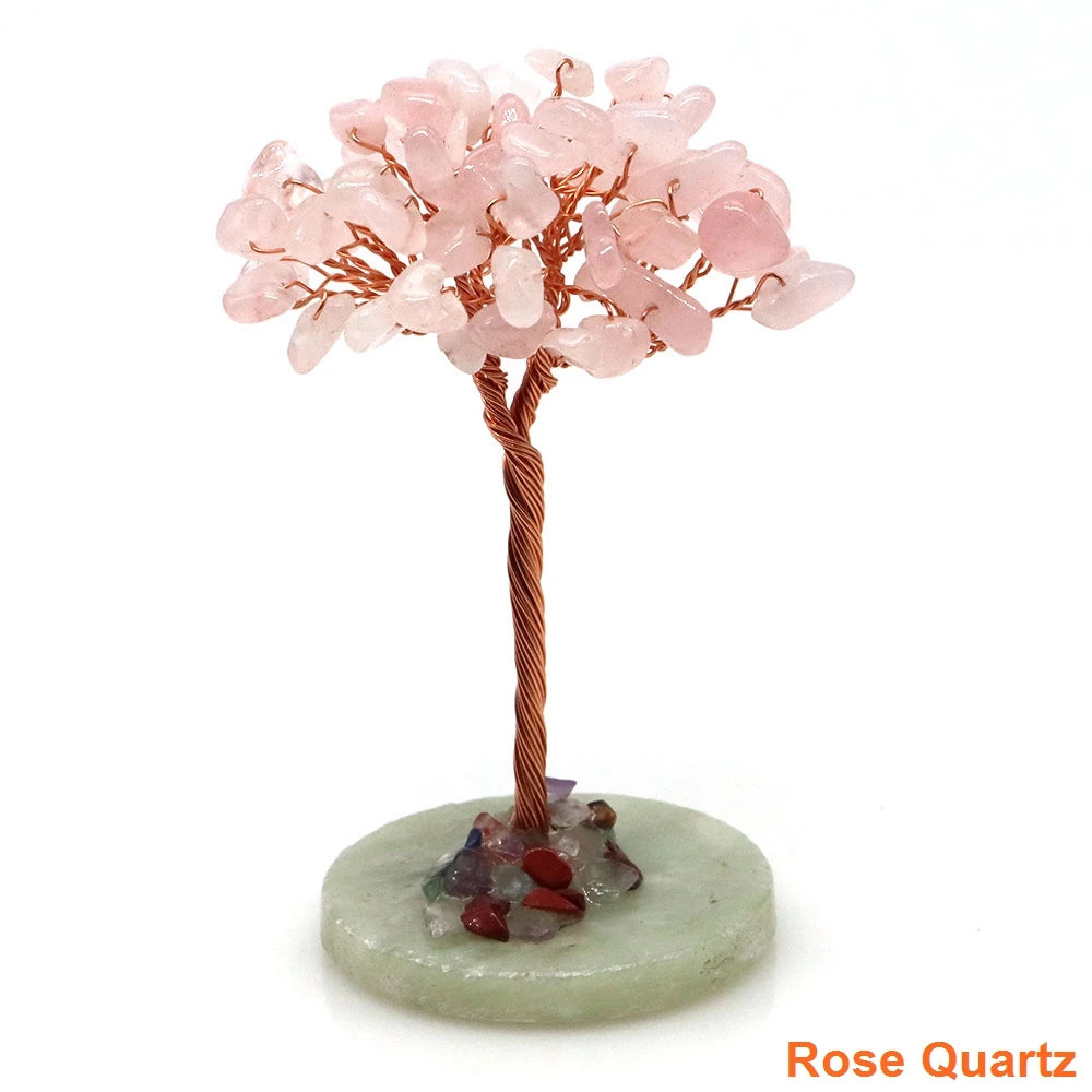 A natural crystal money tree decor featuring pink quartz blossoms on a copper wire stem and a green base.