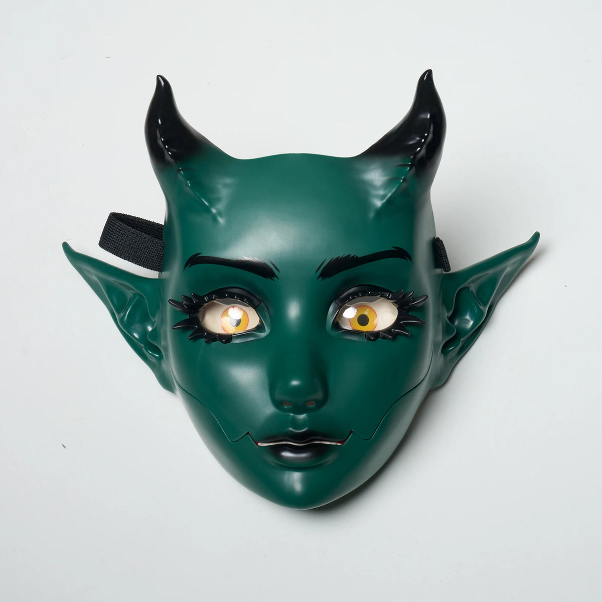 A dark green, horned fantasy creature mask with movable jaw and expressive eyes.