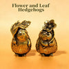 A pair of brass flower and leaf hedgehogs statues for home decor.
