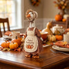 A wooden goose decoration wearing a fabric outfit and headband, set for autumn Thanksgiving decor.