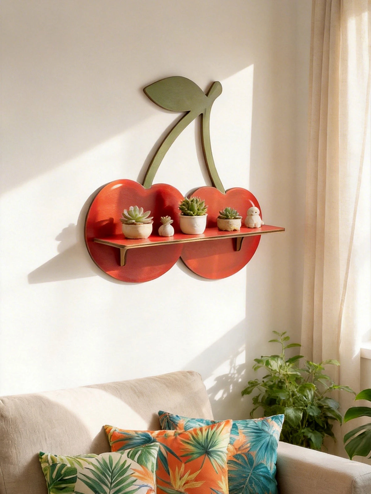 A wooden cherry-shaped wall shelf displaying small potted succulents and decorative figures on a white wall.