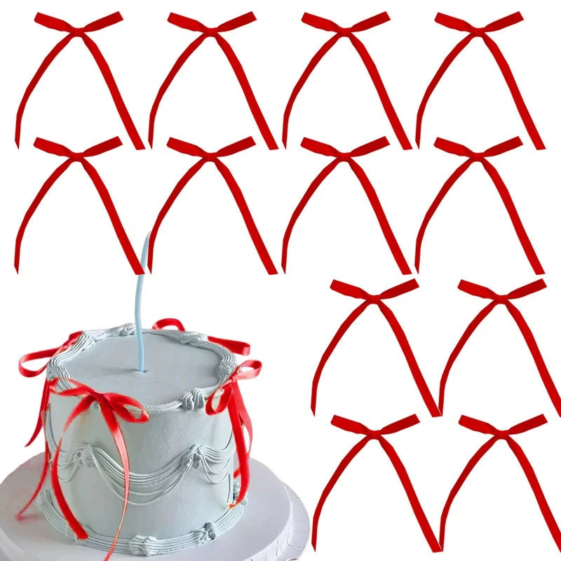 A set of pink bowknot ribbon cake toppers for birthday and wedding cakes displayed next to a round white cake.