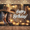 A rustic wooden backdrop featuring cowboy boots and a hat with warm string lights for a birthday party.