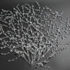 A delicate spray of clear crystal acrylic pendant ornaments arranged on a dark gray background.