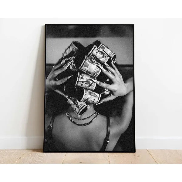 Black and white photograph of a hand holding a wad of cash against a dark background.