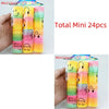 A hand holds a clear plastic package containing 24 colorful mini spring toys in rainbow colors.