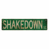 A vintage green metal street sign with the text SHAKEDOWN St.