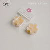 A single handmade soy wax flower tea light candle in a clear plastic pouch with a pink flower charm.