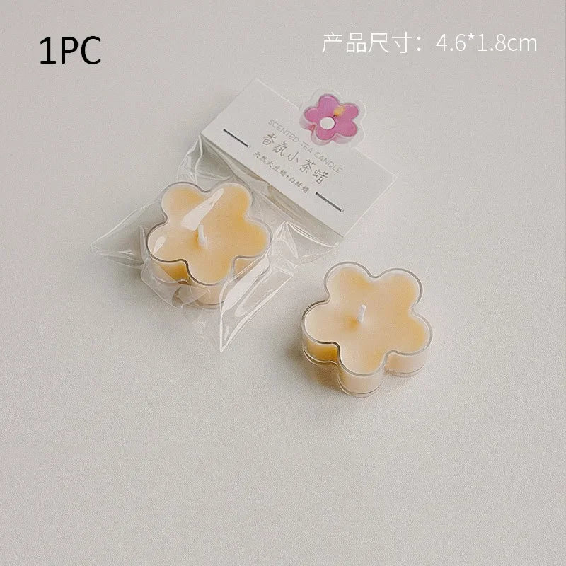 A single handmade soy wax flower tea light candle in a clear plastic pouch with a pink flower charm.