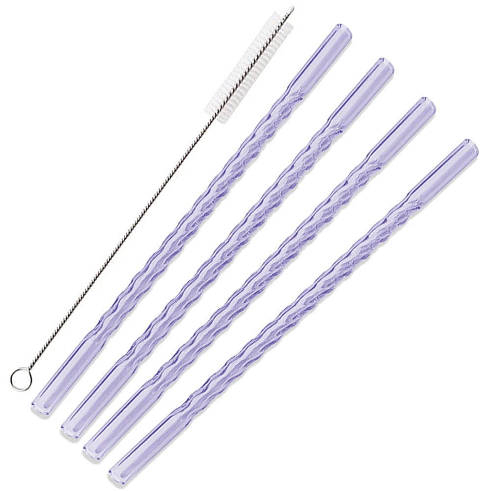 A set of clear reusable borosilicate glass straws with a cleaning brush.