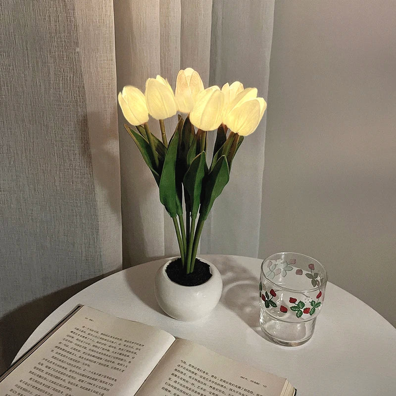 A bouquet of yellow tulips in a white ceramic pot used as an LED night light.